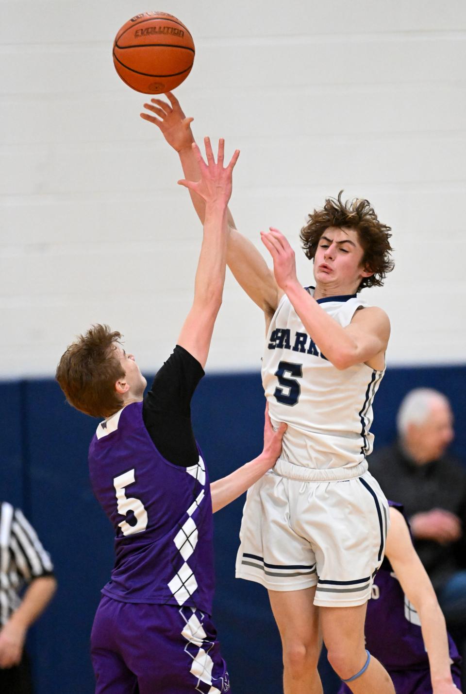 Jackson Rocco of Monomoy passes off under pressure from Sam Zack.