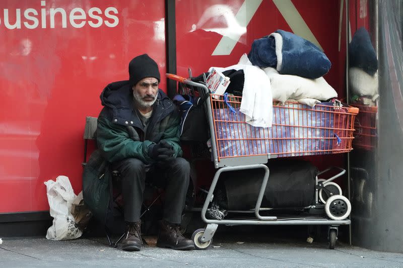 A homeless person sits with his belongings during the outbreak of Coronavirus disease (COVID-19), in the Manhattan borough of New York City