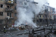 Ukrainian State Emergency Service firefighters work to extinguish a fire at the scene of a Russian shelling in the town of Vyshgorod outside the capital Kyiv, Ukraine, Wednesday, Nov. 23, 2022. Authorities reported power outages in multiple cities of Ukraine, including parts of Kyiv, and in neighboring Moldova after renewed strikes Wednesday struck Ukrainian infrastructure facilities. (AP Photo/Efrem Lukatsky)