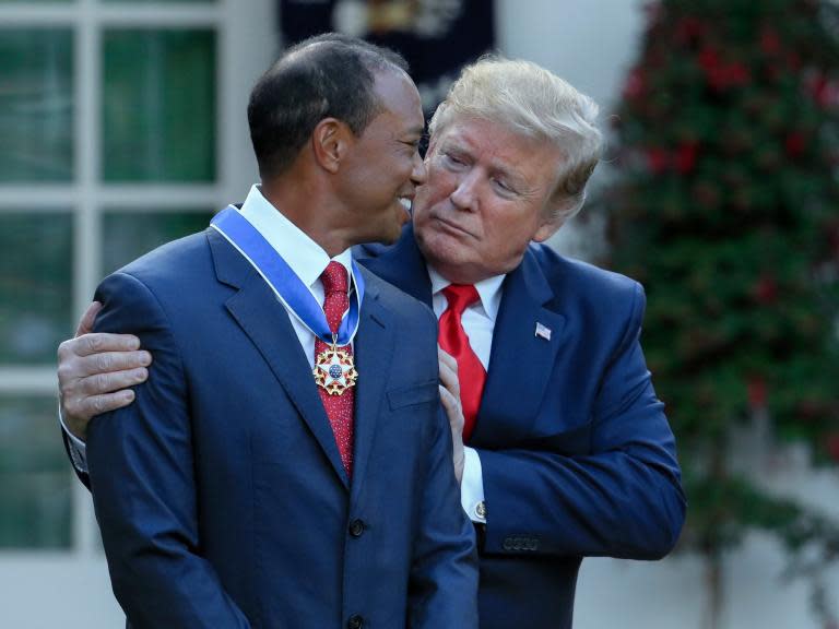 Donald Trump has awarded golfer Tiger Woods the Presidential Medal of Freedom, America's highest civilian honour. The US president called recent Masters winner as a "true legend, an extraordinary athlete who has transformed golf and achieved new levels of dominance," before describing the litany of victories that Woods has obtained during his remarkable career and the injuries that almost derailed it. The Masters was his 15th major golf championship and his 81st overall on the PGA Tour, both ranking second. "He's a great guy," said Mr Trump. "He introduced countless new people to the sport of golf, from every background and walk of life. ... Tiger Woods is a global symbol of American excellence, devotion and drive."Woods, wearing a blue suit was joined at the ceremony by his mother, Kultida, his two children, Sam and Charlie, his girlfriend, Erica Herman, and his caddie, Joe LaCava.The 43-year-old became emotional as he spoke of his parents and thanked those who have supported him over the years. "You've seen the good and bad, the highs and lows, and I would not be in this position without all of your help," he said. The Medal of Freedom is given to individuals who have made "especially meritorious contributions to the security or national interests of the United States, to world peace, or to cultural or other significant public or private endeavours," according to the White House. Presidents have complete discretion over whom they honour it. However, the decision to give the award to Woods has raised questions about whether the president should be boosting the profile of a business associate of the Trump Organisation. The US president has been using the golfer's cachet to attract fans to his properties for decades.After Wood's first Masters victory in 1997, Mr Trump got him to turn up at his Taj Mahal casino in Atlantic City, New Jersey. The place was mobbed as 2,000 fans showed up told watch him walk down a 320-foot red carpet, some of them storming steel barricades to get a closer look. Mr Trump has also struck business deals with Woods. Golfers at Trump's club in Doral, Florida, can stay at the Tiger Woods Villa. At a ribbon cutting ceremony in 2014, Woods lavished praise on the future presidential candidate, calling changes he made to the club "phenomenal." Woods designed an 18-hole course to be managed by The Trump Organisation in Dubai. The Trump Organisation has "repeatedly demonstrated their ability to successfully manage unique, high-end courses and golf clubs, and this is no exception," Woods said in a 2018 interview in the company's in-house magazine. Ethics officials have criticised Mr Trump for not selling off his assets completely and holding the money in a blind trust. Instead, he set up a trust to hold his assets, handed day-to-day management responsibilities to two sons and hired an ethics lawyer to vet business deals."You have to ask whether it's his true belief Tiger Woods deserves this award or whether he's doing it to help his business," Jordan Libowitz, communications director at Citizens for Responsibility and Ethics in Washington, a left-leaning public policy group, told the Associated Press.Christopher Devine, an associate professor of political science at the University of Dayton, said Trump may have a business angle. Support free-thinking journalism and subscribe to Independent MindsHowever, he added that he believed Woods was deserving and calls his Masters victory "the greatest comeback in sports of all time." "If President Obama or Hillary Clinton had given the award to Tiger, no one would have batted an eye," Prof Devine said. Woods is the fourth professional golfer to receive the award. George W Bush presented the Medal of Freedom to Arnold Palmer and Jack Nicklaus and Mr Obama presented it to Charlie Sifford, sometimes referred to as the "Jackie Robinson of golf."