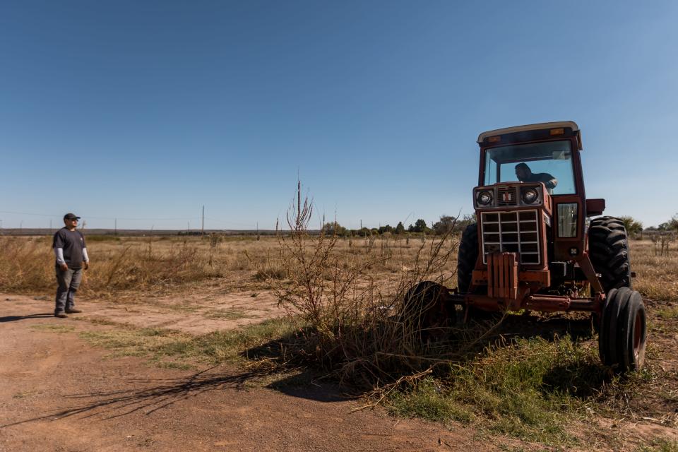 Victor Sanchez and Alfonso Deleon fix a tractor in El Paso's Lower Valley on Oct. 28.