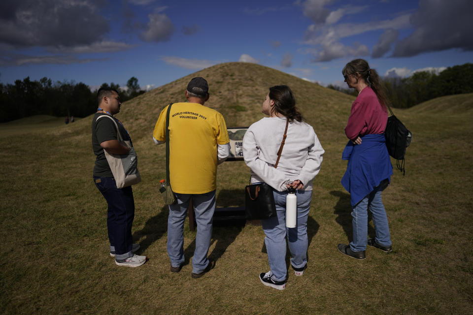 Visitors tour the Mound City Group at Hopewell Culture National Historical Park in Chillicothe, Ohio, Saturday, Oct. 14, 2023, before the Hopewell Ceremonial Earthworks UNESCO World Heritage Inscription Commemoration ceremony. A network of ancient American Indian ceremonial and burial mounds in Ohio noted for their good condition, distinct style and cultural significance, including Hopewell Culture National Historical Park, was added to the list of UNESCO World Heritage sites. (AP Photo/Carolyn Kaster)