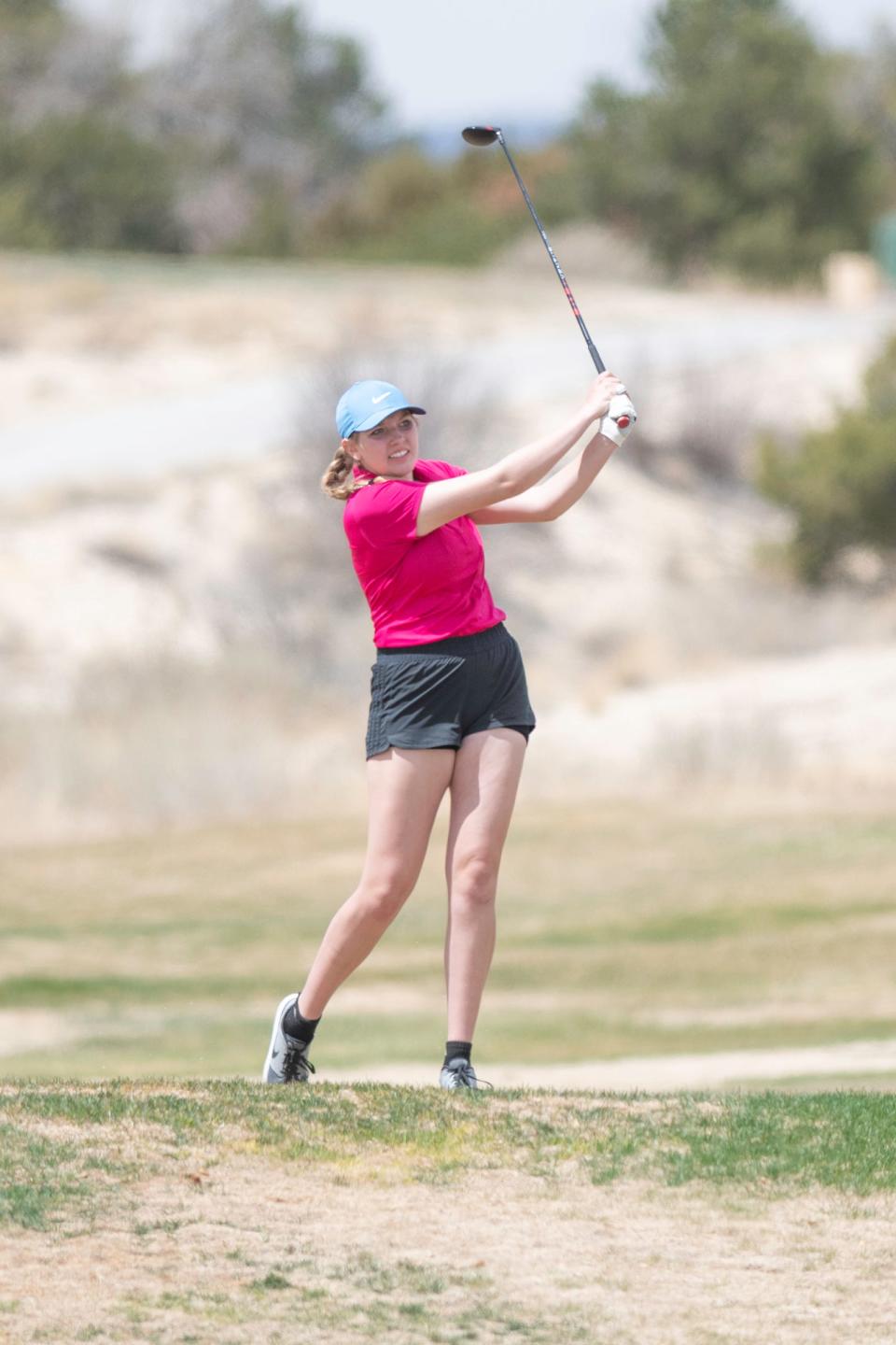 Pueblo West's Clayre Wagner watches her tee shot on the fifth hole during a tournament at Four Mile Ranch Golf Club on April 13.