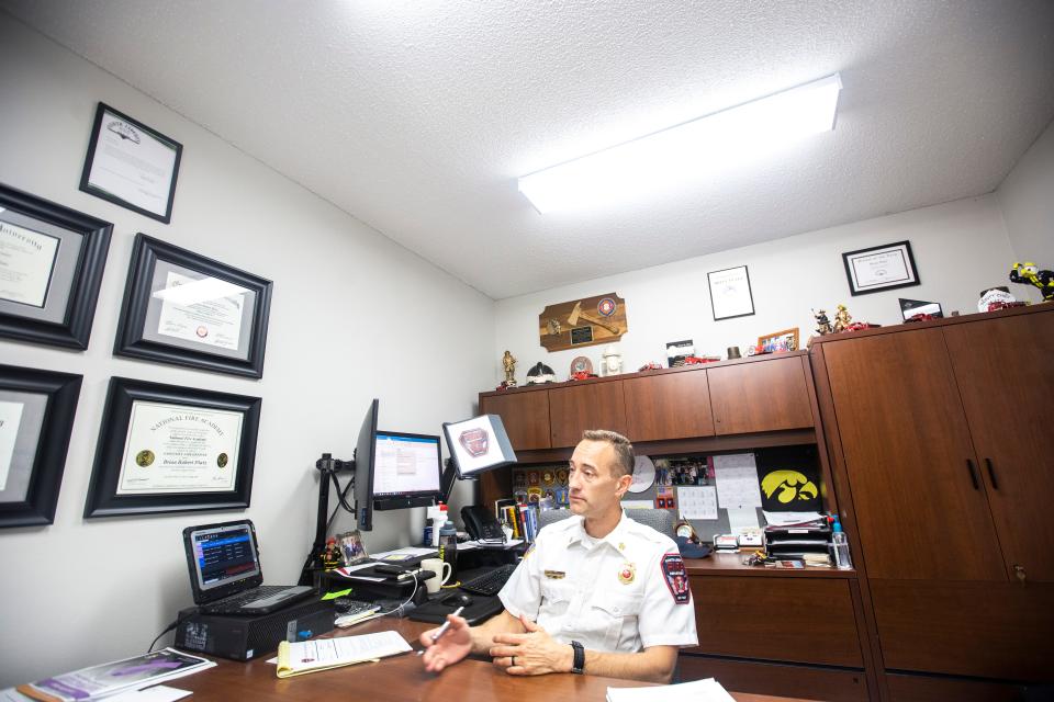 North Liberty Fire Chief Brian Platz, shown at his desk in 2019, is looking forward to bringing on three additional firefighters to help his force handle the needs of the rapidly growing city.