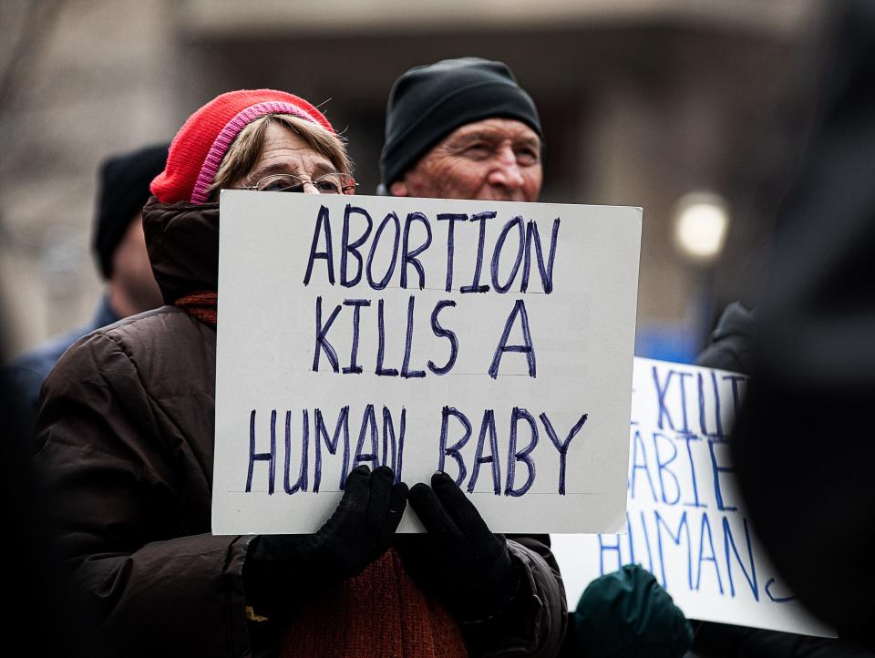 A woman held up an anti-abortion sign during a Right to Life rally at the steps of Louisivlle Metro Hall. Right to Life of Louisville hosted the rally to commemorate the 49th anniversary of Roe v Wade. January 21, 2022