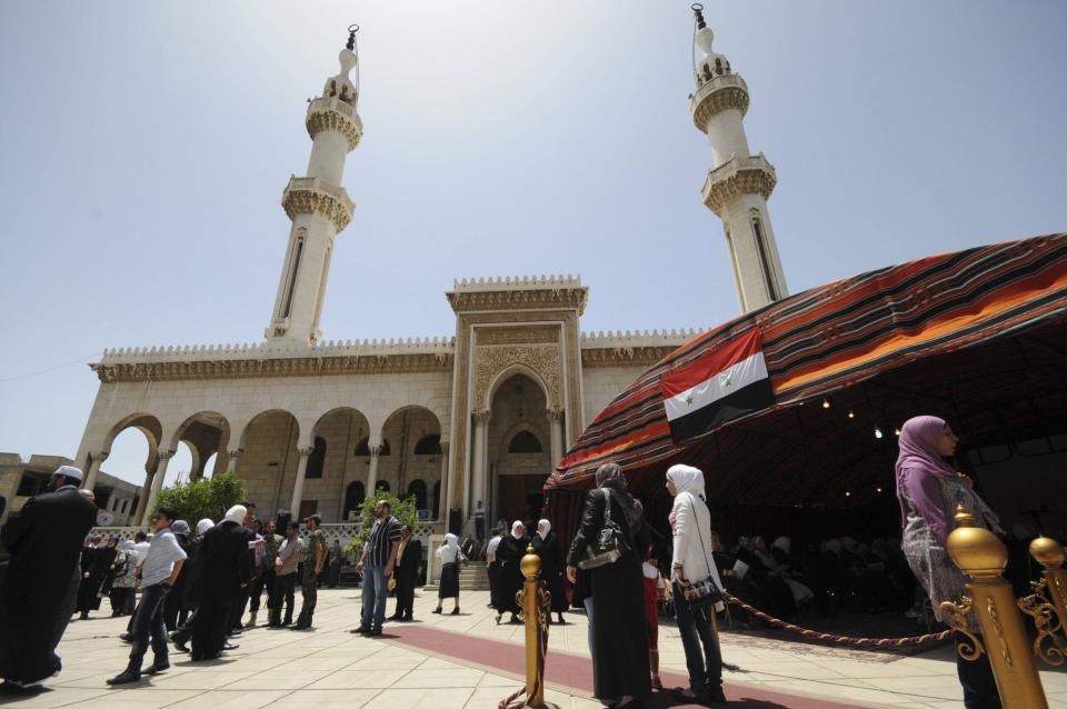 People arrive to cast their votes at a polling station at al-Othman mosque in Damascus June 3, 2014. (REUTERS/Omar Sanadiki)