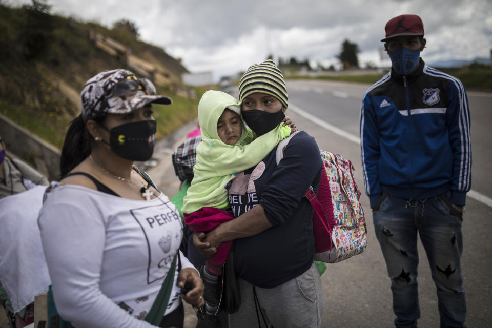 Venezuelan migrants rest as they walk towards Bogota, passing through Tunja, Colombia, Tuesday, Oct. 6, 2020. Immigration officials in Colombia expect 200,000 Venezuelans to enter the country in the following months, enticed by the prospects of earning higher wages and sending money home to feed their families. (AP Photo/Ivan Valencia)