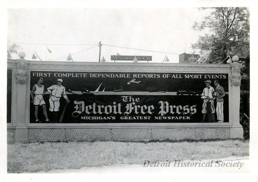 A Walker & Co. billboard displays an advertisement in 1924 for the Detroit Free Press that reads, "First Complete Dependable Reports of all Sport Events, The Detroit Free Press, Michigan's Greatest Newspaper."