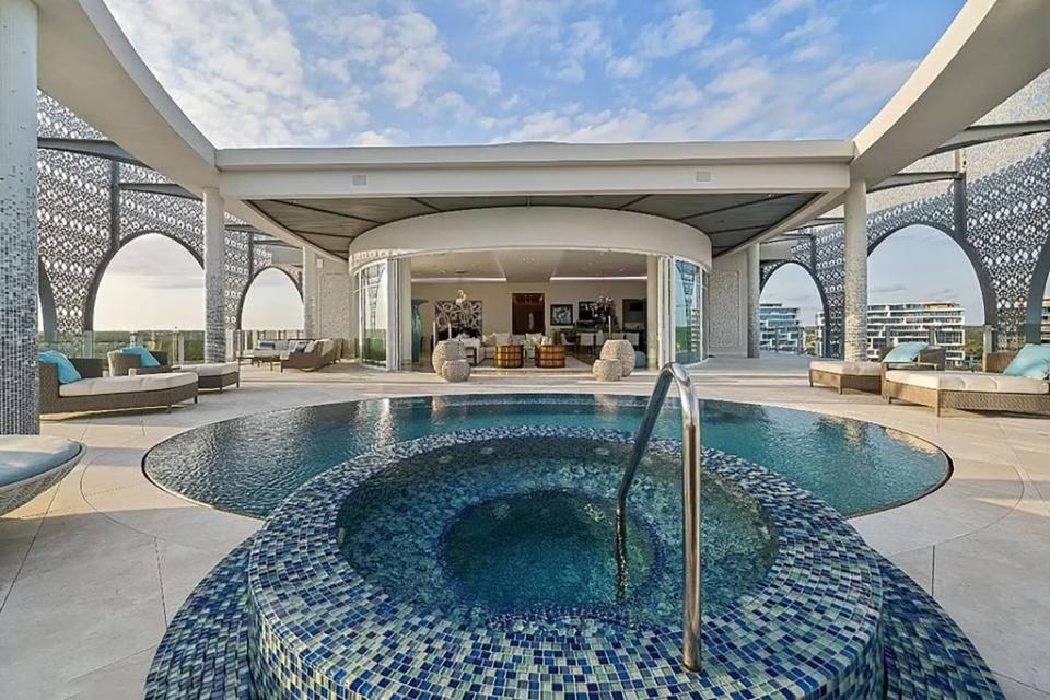 The pool and spa seen during the day. Seaside Real Estate/ Bahamas MLS