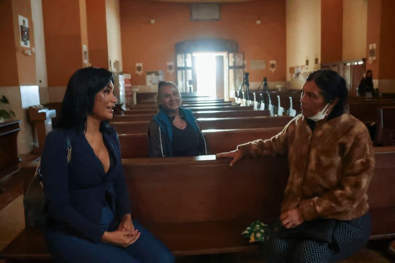 Carla and Claudia Victoria sit inside the Blessed Immaculate Virgin Church in Torvaianica