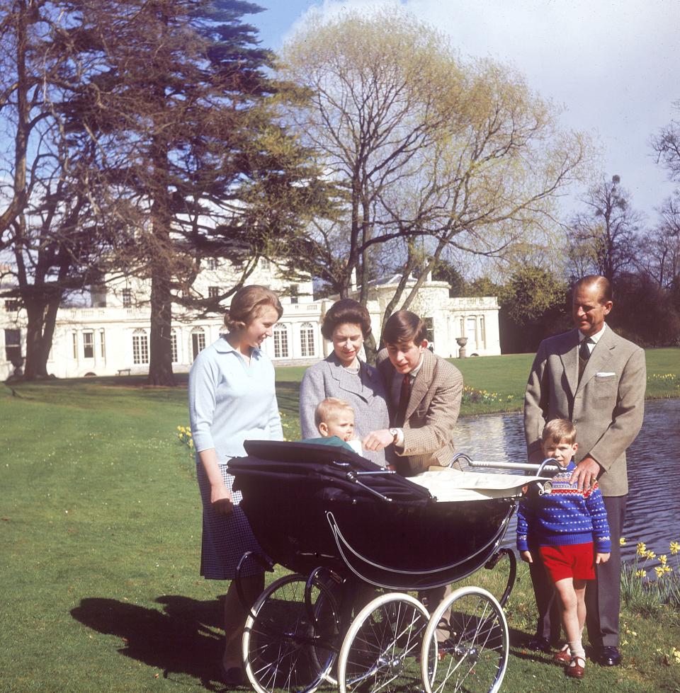 Prince Charles dotes on his youngest brother, Prince Edward, at Frogmore House, during a family photo op.