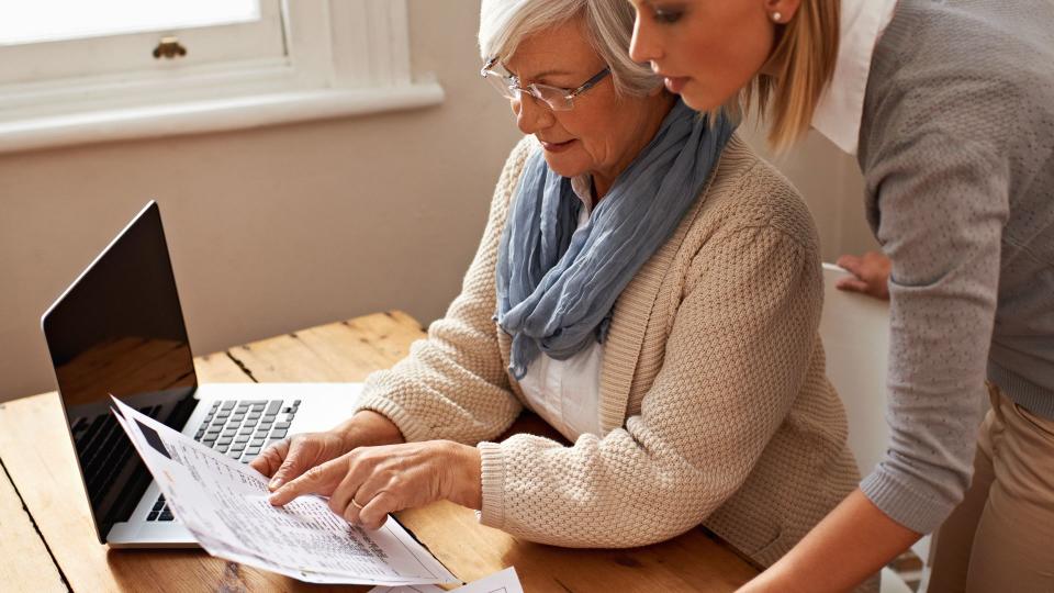 senior woman receiving help with her finances