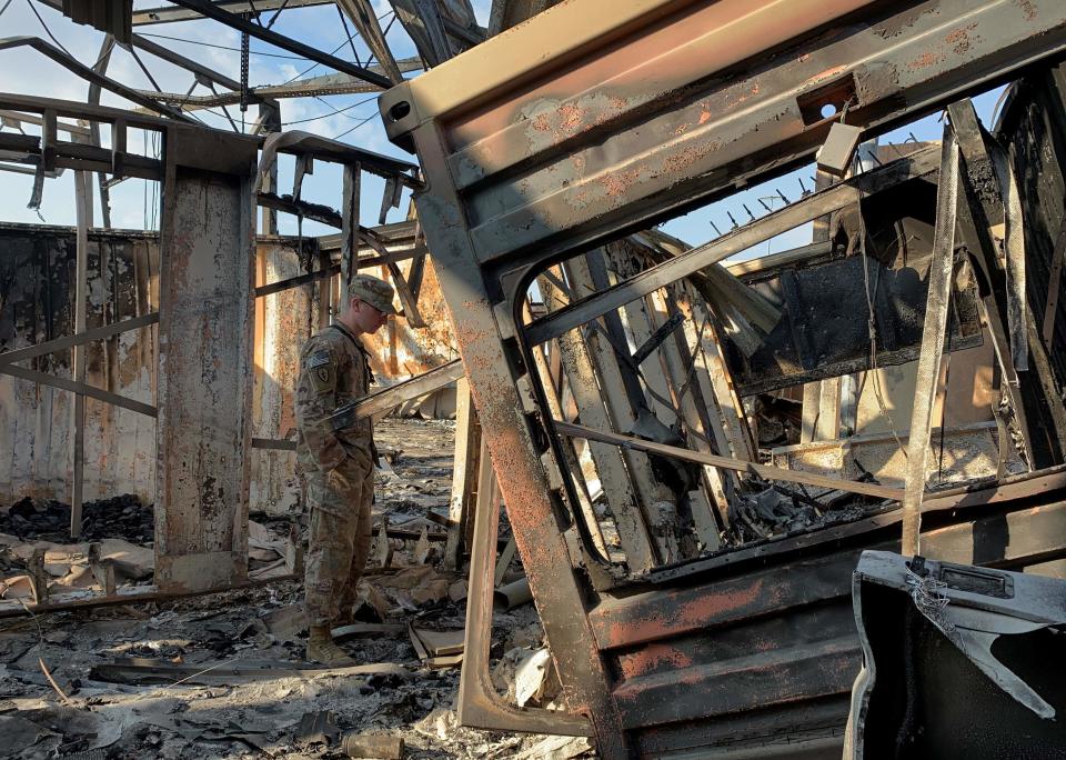 A U.S. military servicemember stands amid the damage at Ain al-Asad military base in Iraq on Jan. 13, 2020, during a press tour organized by the U.S.-led coalition less than a week after Iran's missile attack.