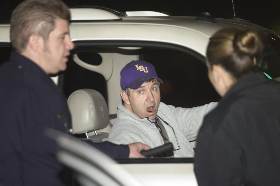 Jamie Spears, the father of pop singer Britney Spears, talks with two police officers at the entrance of the Cedars Sinai Hospital in Beverly Hills, California, January 4, 2008. The singer was taken to a Los Angeles hospital early on Friday, after police spent about four hours at her house trying to mediate a custody dispute, according to witnesses. She was escorted from her hilltop home overlooking Beverly Hills in one of three ambulances that was part of a convoy of nine police vehicles and a handful of other cars.    REUTERS/Hector Mata (UNITED STATES)