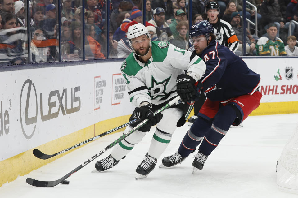 Dallas Stars' Luke Glendening, left, looks for an open pass as Columbus Blue Jackets' Marcus Bjork defends during the third period of an NHL hockey game on Monday, Dec. 19, 2022, in Columbus, Ohio. (AP Photo/Jay LaPrete)