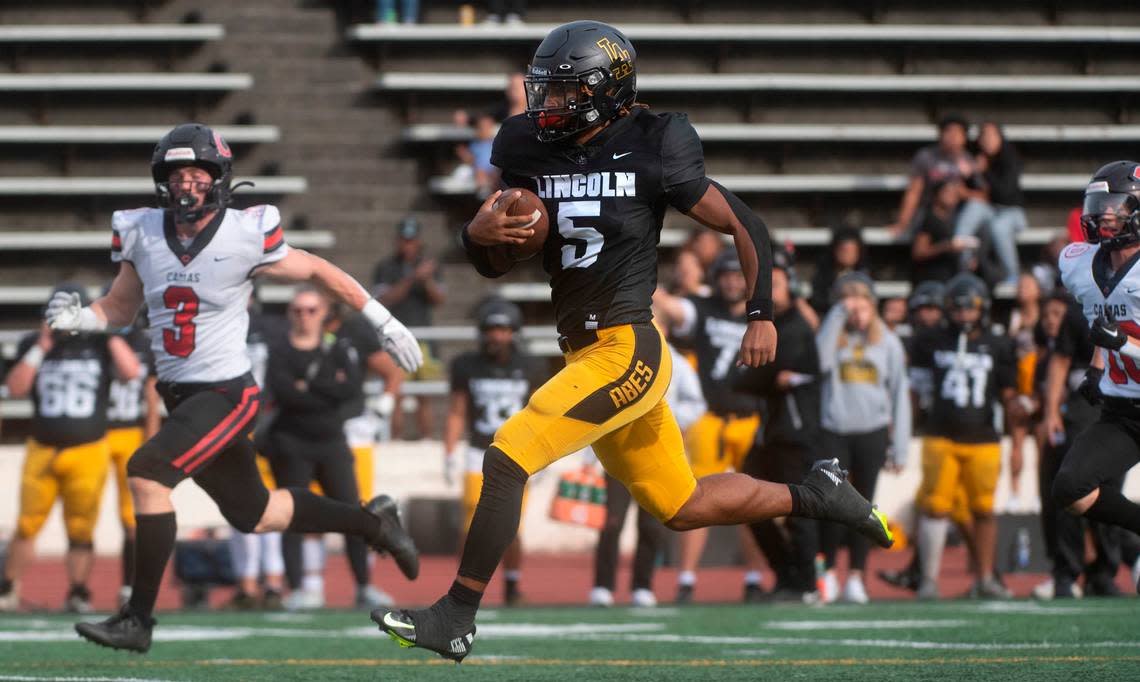 Lincoln quarterback Gabarri Johnson breaks loose for the first of two touchdown runs against the Camas Papermakers in Saturday afternoon’s 4A football game at Lincoln Bowl in Tacoma, Washington, on Sept. 17, 2022. Lincoln won the game, 42-28.