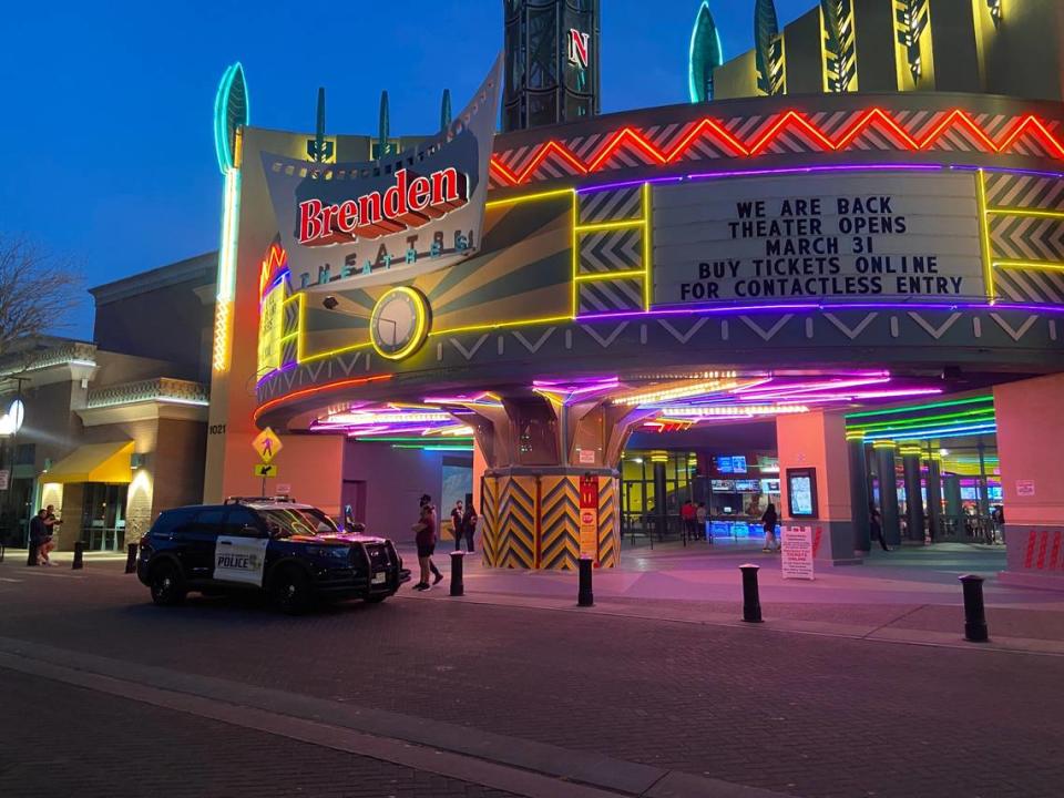 A police car sits outside the Brenden Theatres location on 10th Street on Friday, April 2, 2021.