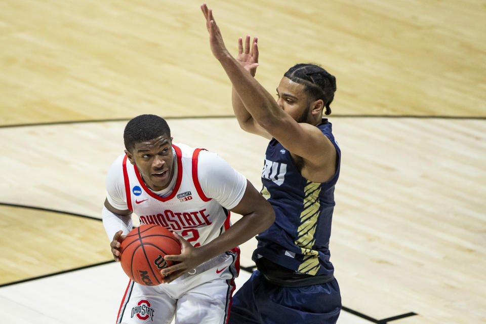 Ohio State's E.J. Liddell, left, gets pressure from Oral Roberts' Kevin Obanor during the first half of a First Round game in the NCAA men's college basketball tournament, Friday, March 19, 2021, at Mackey Arena in West Lafayette, Ind. (AP Photo/Robert Franklin)