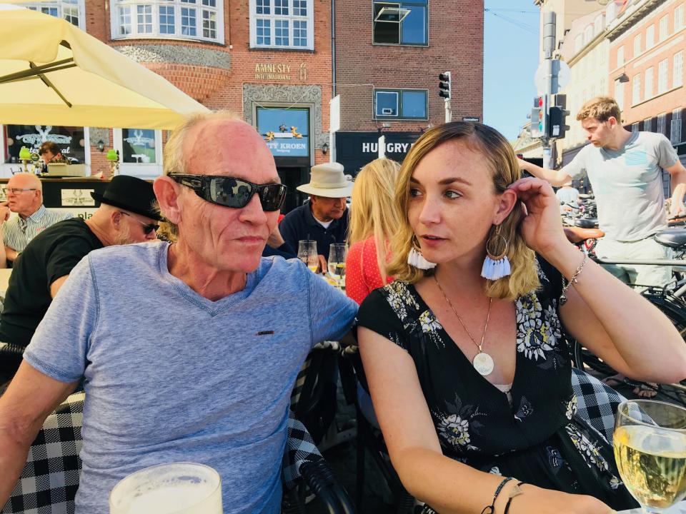 Malcom Madsen (left) and his daughter, Brooke Mullins, sit on a patio in Denmark in July 2018. Madsen went missing in Puerto Vallarta, Mexico three months later, and Brooke has been trying to find out what happened ever since. (Photo via Brooke Mullins)