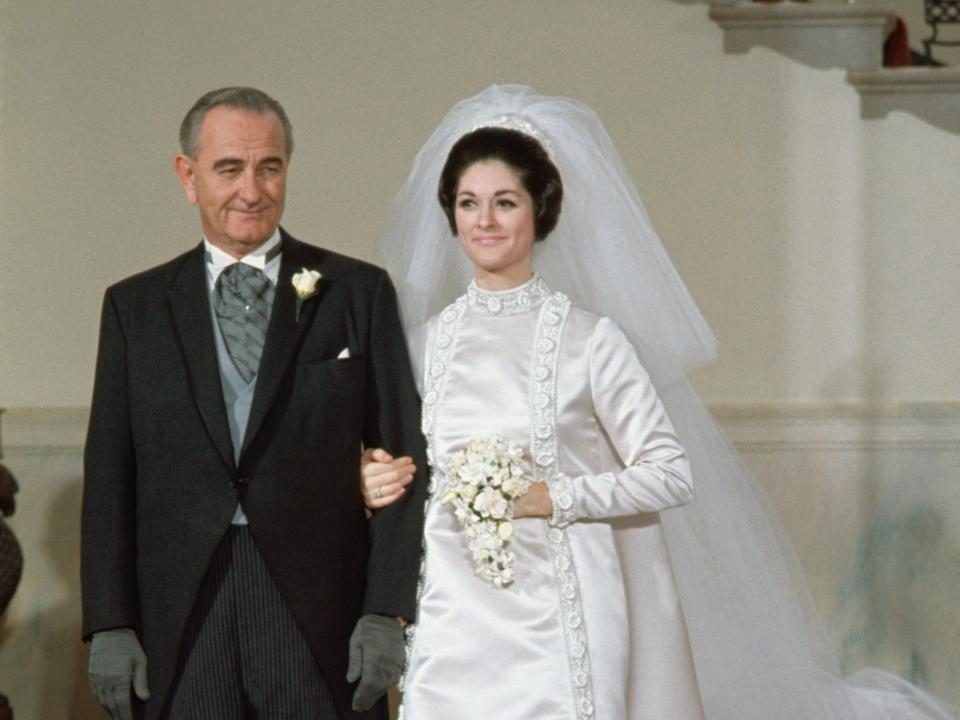 President Lyndon Johnson escorts daughter Lynda Bird Johnson on her wedding day.