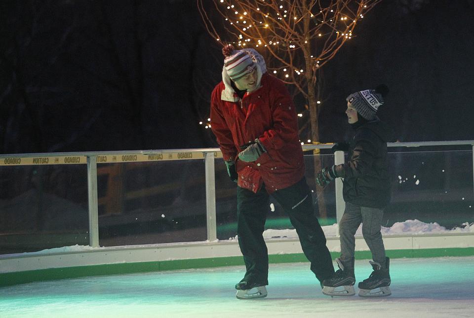 Justin Johansen and his son, Vincent Highland, 9, skate Jan. 7 at the ice rink.