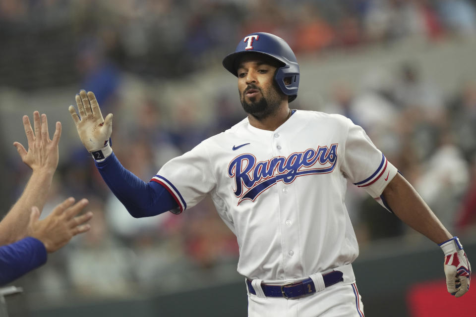 Texas Rangers' Marcus Semien is congratulated after hitting a solo home run during the first inning of a baseball game against the Detroit Tigers in Arlington, Texas, Monday, June 26, 2023. (AP Photo/LM Otero)