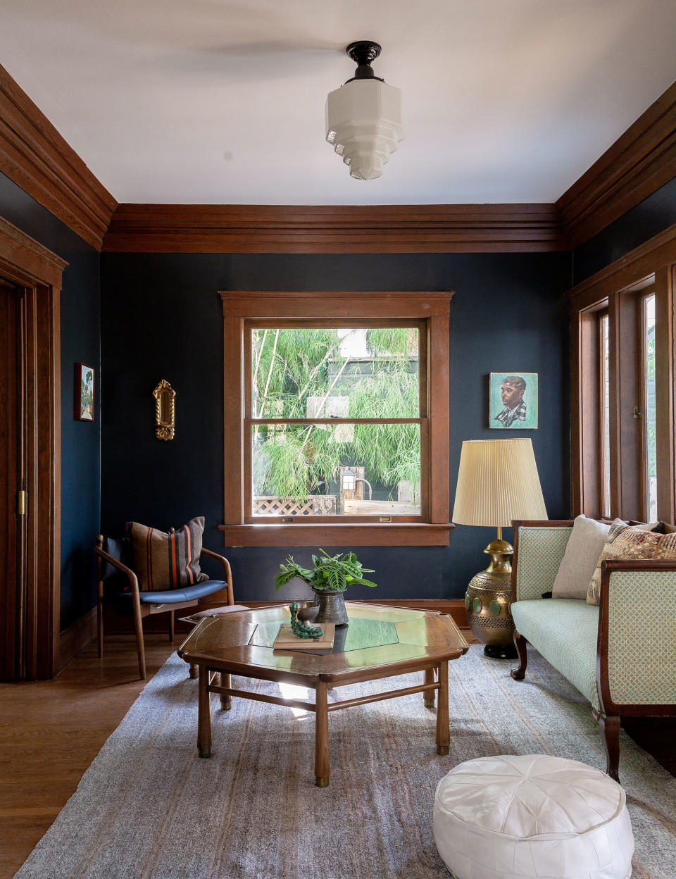 Small living room with dark color scheme and brown furniture