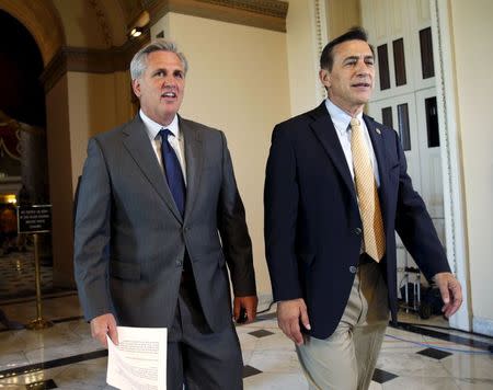 House Majority Leader Kevin McCarthy (R-CA), L, and Rep. Darrell Issa (R-CA) walk to the House Chamber where members of congress were voting on a package of trade bills in the U.S. Capitol in Washington June 12, 2015. REUTERS/Kevin Lamarque