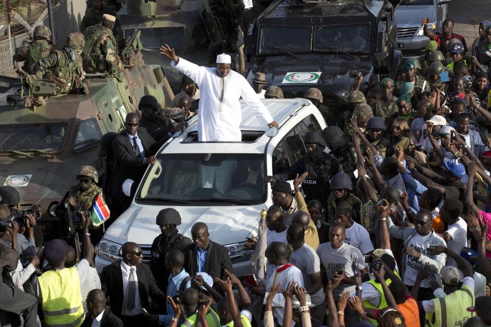 Gambian President Adama Barrow greets the crowds after arriving at Banjul airport in Gambia, Thursday Jan. 26, 2017, after flying in from Dakar, Senegal. Gambia's new president has finally arrived in the country, a week after taking the oath of office abroad amid a whirlwind political crisis. Here's a look at the tumble of events that led to Adama Barrow's return — and the exile of the country's longtime leader. (AP Photo/Jerome Delay)