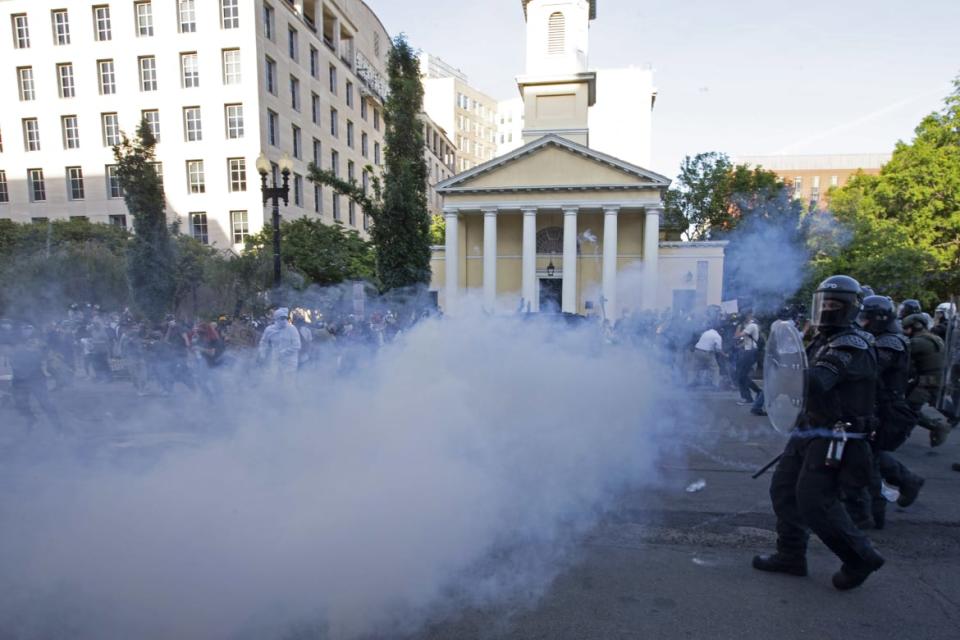 <div class="inline-image__caption"><p>Police officers wearing riot gear push back demonstrators next to St. John's Episcopal Church so President Trump could visit.</p></div> <div class="inline-image__credit">Jose Luis Magana/AFP via Getty</div>