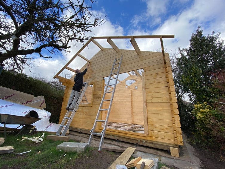 <span class="caption">Painting the front of our tiny house.</span> <span class="attribution"><span class="license">Author provided</span></span>