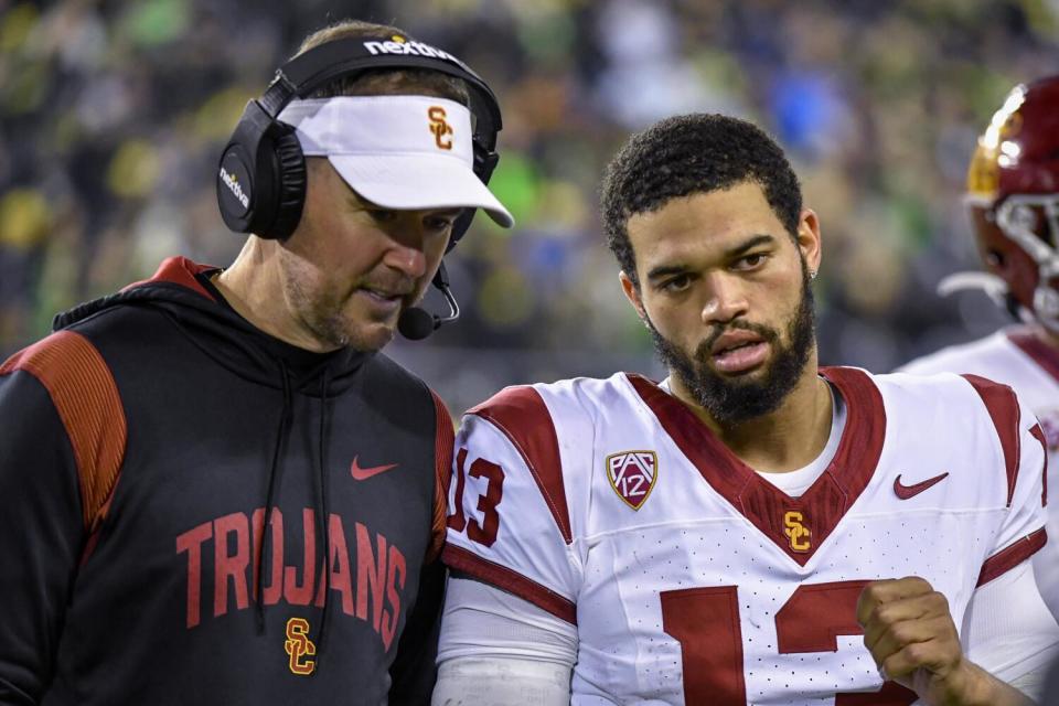 USC coach Lincoln Riley and quarterback Caleb Williams confer on the sideline.