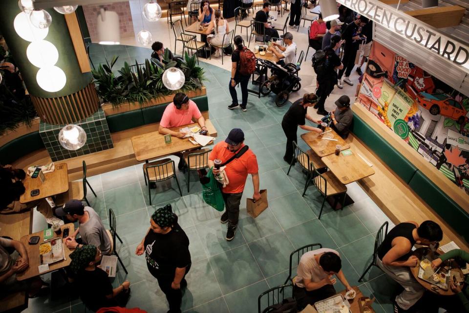 Customers and staff are shown inside Shake Shack on Thursday.