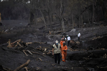 Members of the Guatemala's disaster management agency (CONRED) inspect an area affected by a lahar from Fuego volcano at El Rodeo, Guatemala June 13, 2018. REUTERS/Jose Cabezas