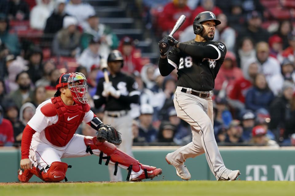 Chicago White Sox's Leury Garcia (28) follows through on a sacrifice fly that scored Jake Burger as Boston Red Sox's Christian Vazquez looks on during the ninth inning of a baseball game, Saturday, May 7, 2022, in Boston. (AP Photo/Michael Dwyer)