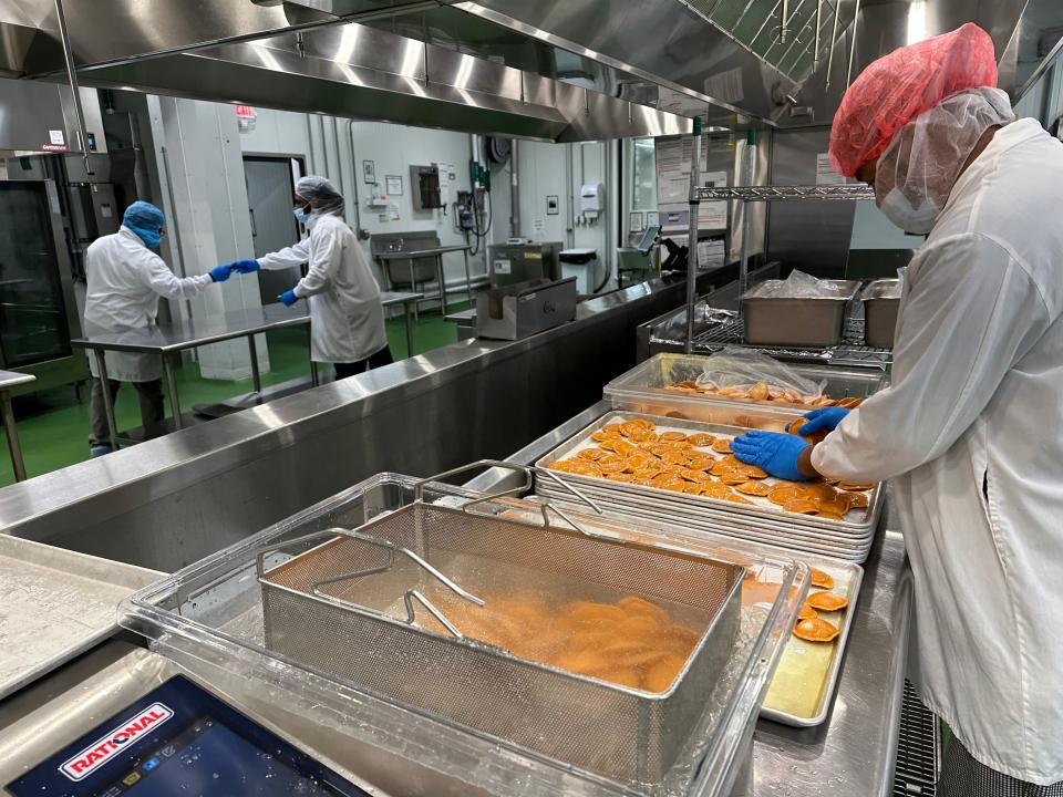 Pumpkin ravioli getting chilled and oiled after being cooked.