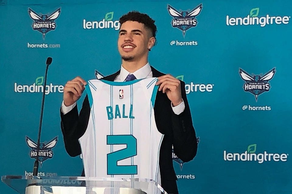 LaMelo Ball, selected by the Charlotte Hornets with the No. 3 overall pick in the NBA draft, holds up his jersey during an introductory news conference on Friday, Nov. 20, 2020, in Charlotte, N.C. (AP Photo/Steve Reed)