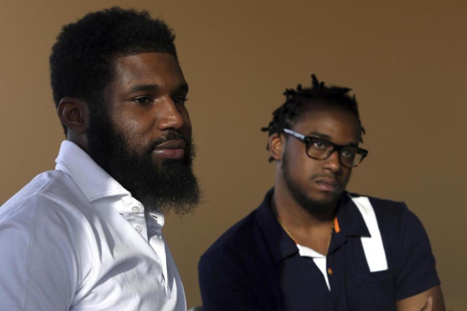 Rashon Nelson, left, and Donte Robinson, right, have reached a financial settlement over their arrests in a Philadelphia Starbucks (AP)