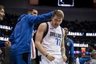 Dec 8, 2018; Dallas, TX, USA; Dallas Mavericks forward Luka Doncic (77) celebrates with center Salah Mejri (50) and teammates on the bench after scoring eleven points in a row against the Houston Rockets during the second half at the American Airlines Center. Jerome Miron-USA TODAY Sports