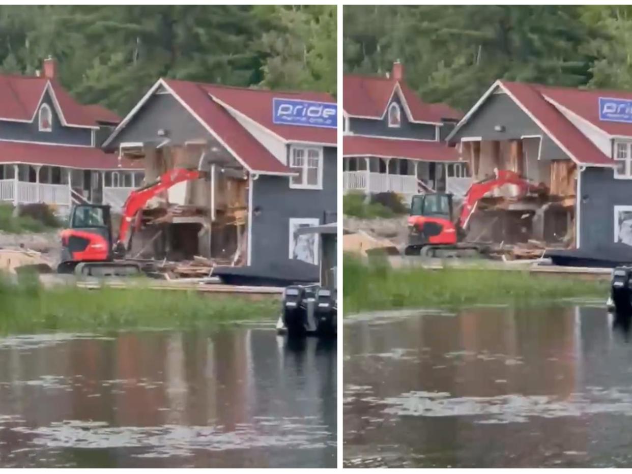 Video shows a red excavator tearing down a marina building in Ontario, Canada.
