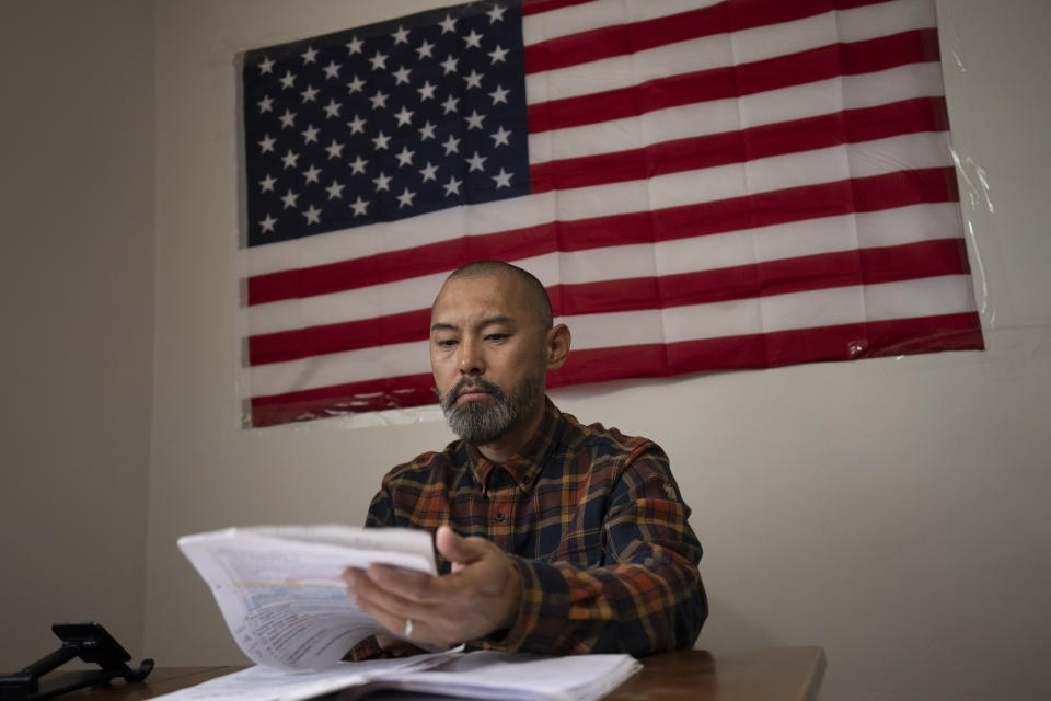 Chinese migrant Li Kai aka Khaled, an ethnic Hui Muslim, studies for a Commercial Driving License in his apartment in Flushing, New York, Friday, May 3, 2024. Li Kai came to the U.S. with his wife and two sons seeking religious freedom and a better life. The daily struggle to find work for Chinese immigrants living illegally in New York is a far cry from the picture Donald Trump and other Republicans have sought to paint about them. Asian advocacy organizations say they're concerned the exaggerated rhetoric could fuel further harassment against Asians in the U.S. (AP Photo/Serkan Gurbuz)