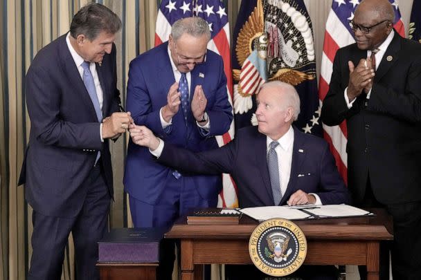 PHOTO: President Joe Biden gives Sen. Joe Manchin the pen he used to sign The Inflation Reduction Act with Senate Majority Leader Charles Schumer and House Majority Whip James Clyburn in the State Dining Room of the White House Aug. 16, 2022. (Drew Angerer/Getty Images)