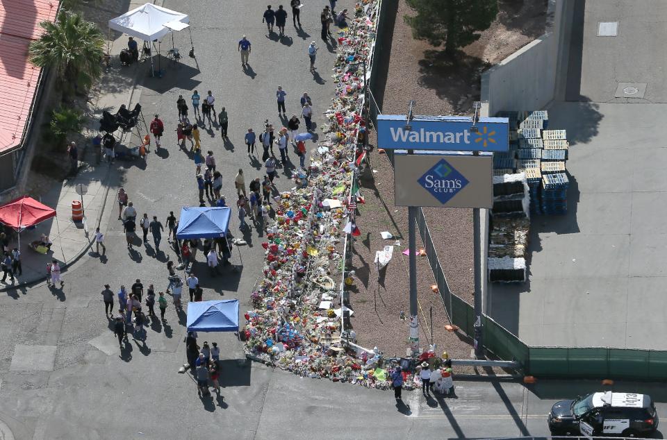 An aerial photograph of the memorial near the Walmart near Cielo Vista Mall, where a shooting that killed 22 and wounded 25 others happened Saturday, Aug. 3. Some vehicles still remain at the crime scene.