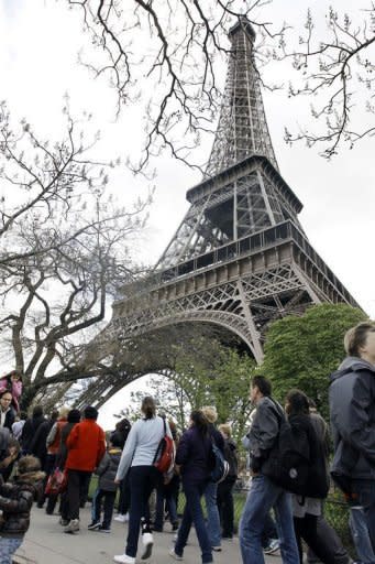 Visitors queue up in front of the Eiffel Towe. The east pillar lift is the only one in operation