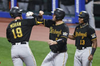 Pittsburgh Pirates' Colin Moran (19) celebrates with Jacob Stallings (58) and Ke'Bryan Hayes (13) after hitting a three-run home run off Cleveland Indians pitcher Aaron Civale during the fourth inning of a baseball game Saturday, Sept. 26, 2020, in Cleveland. (AP Photo/Ron Schwane)