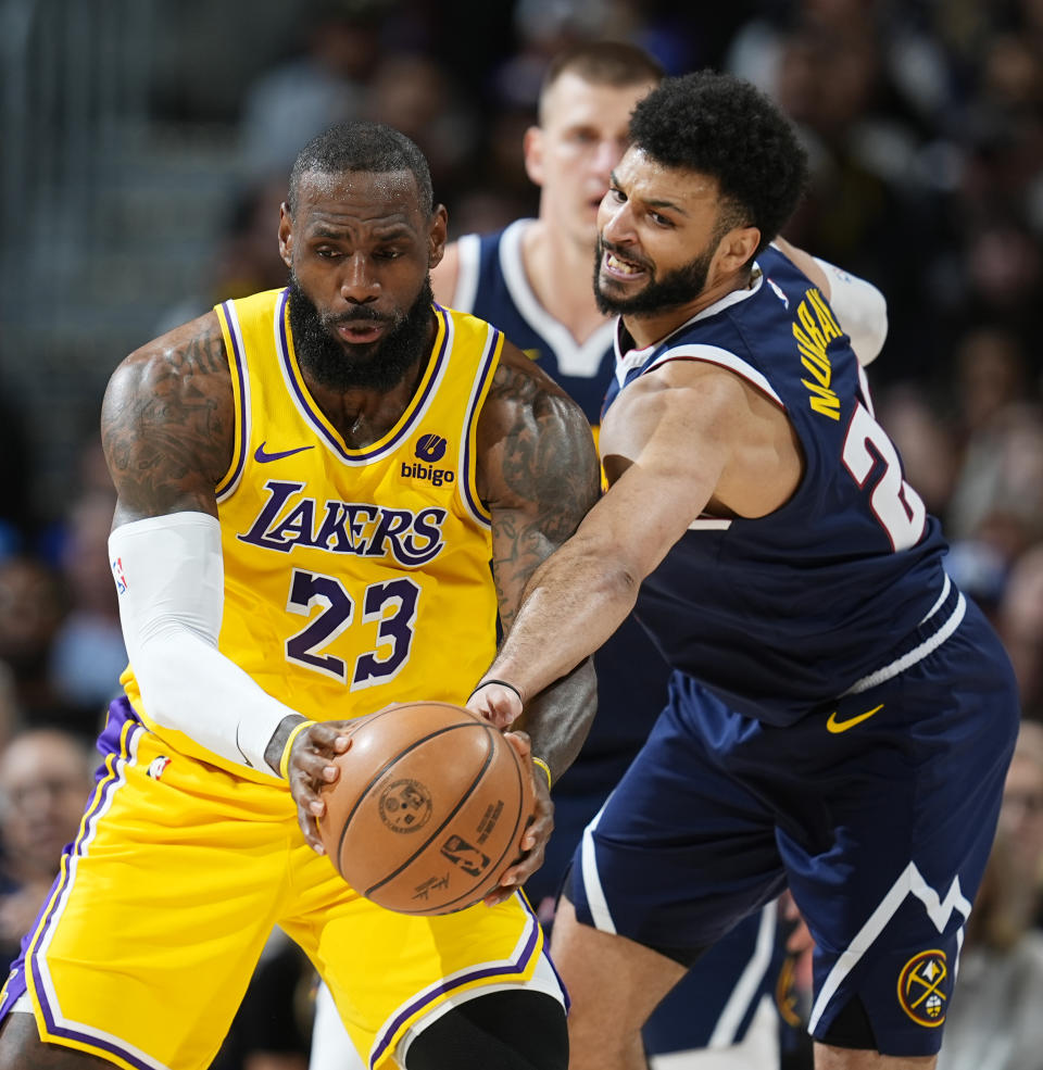 Los Angeles Lakers forward LeBron James, left, fields a pass as Denver Nuggets guard Jamal Murray, right, tries to make a steal in the first half of Game 5 of an NBA basketball first-round playoff series Monday, April 29, 2024, in Denver. (AP Photo/David Zalubowski)
