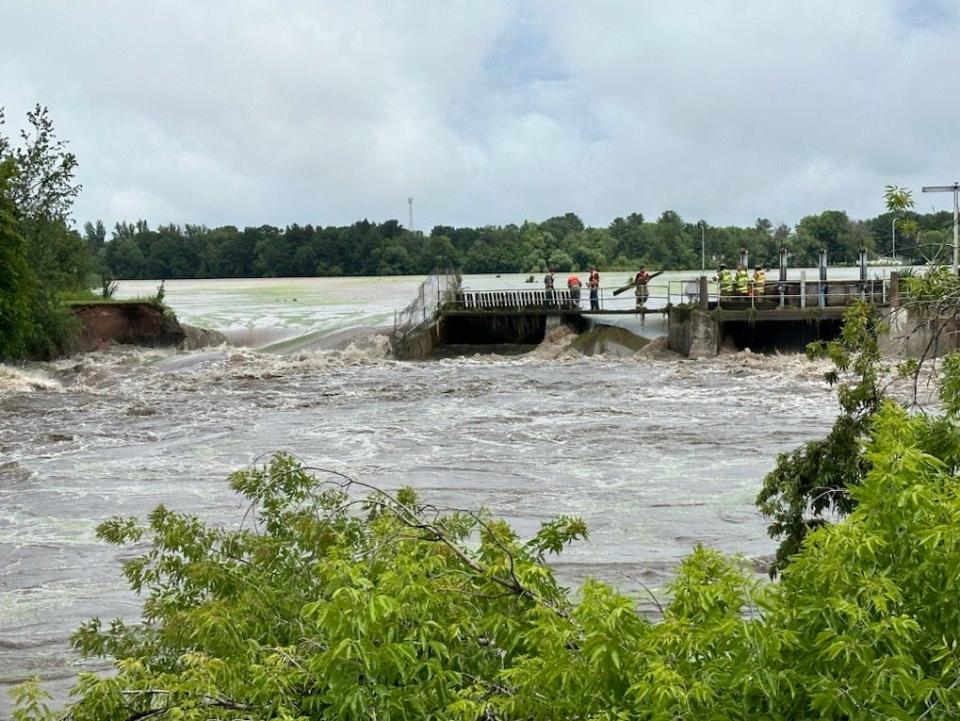 Water pours over the Manawa dam on July 5, 2024.