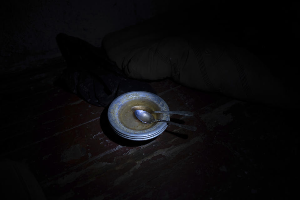 Spoons sit in a stack of bowls at a police department, left behind after the area was liberated from Russian forces, in Izium, Ukraine, Thursday, Sept. 22, 2022. Ukrainian civilians said they were held and tortured at this site by Russian soldiers. (AP Photo/Evgeniy Maloletka)