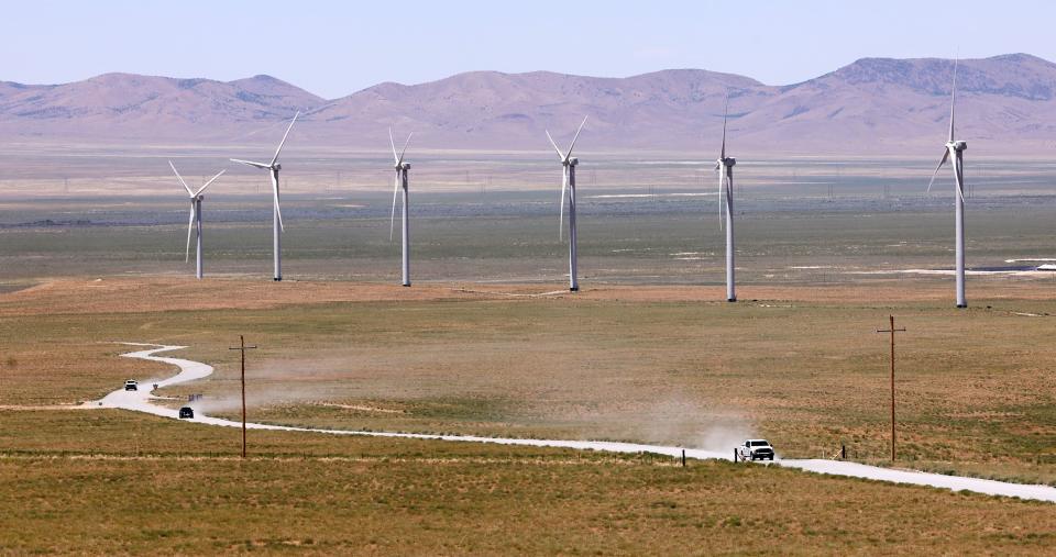 Cars drive on a dirt road near the site of the FORGE geothermal demonstration area and wind turbines near Milford on Thursday, July 6, 2023. | Scott G Winterton, Deseret News