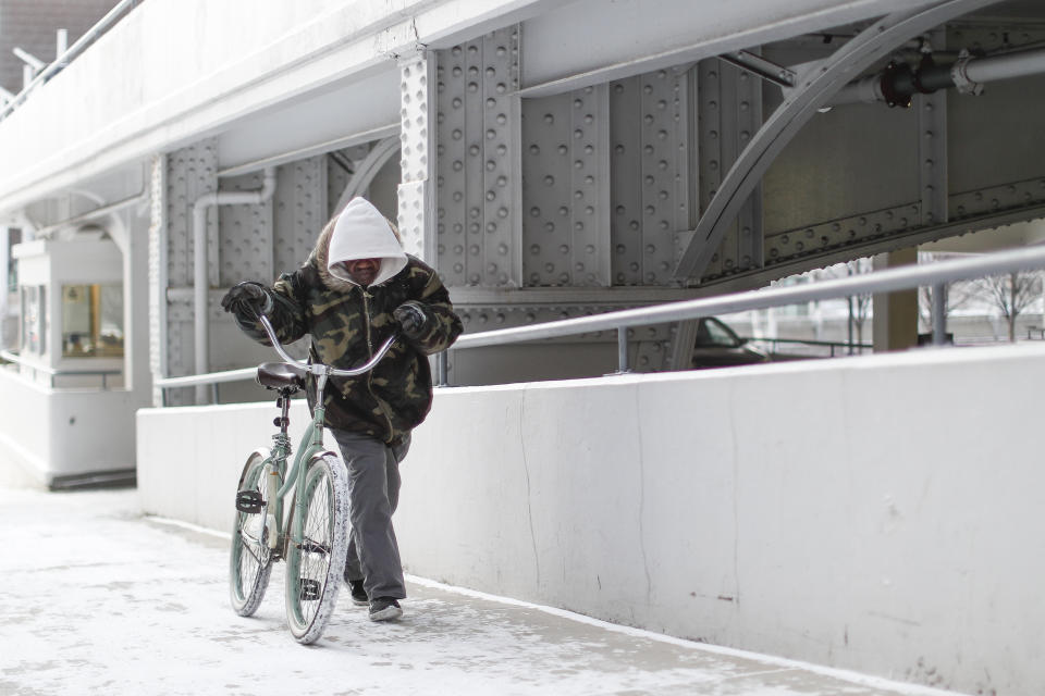 A commuter braves the wind and snow in frigid weather, Wednesday, Jan. 30, 2019, in Cincinnati.&nbsp;